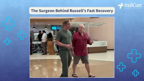 Russell Eddy speaking with his hip replacement surgeon, Dr. Mudit Khanna, in a hospital lobby area, suggesting an informal post-consultation discussion.